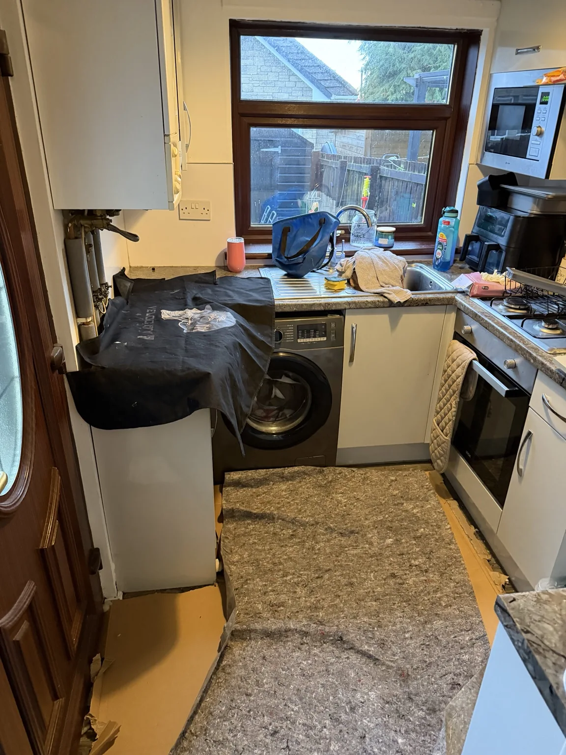 Protective sheeting placed on kitchen floor and worktops ahead of boiler work