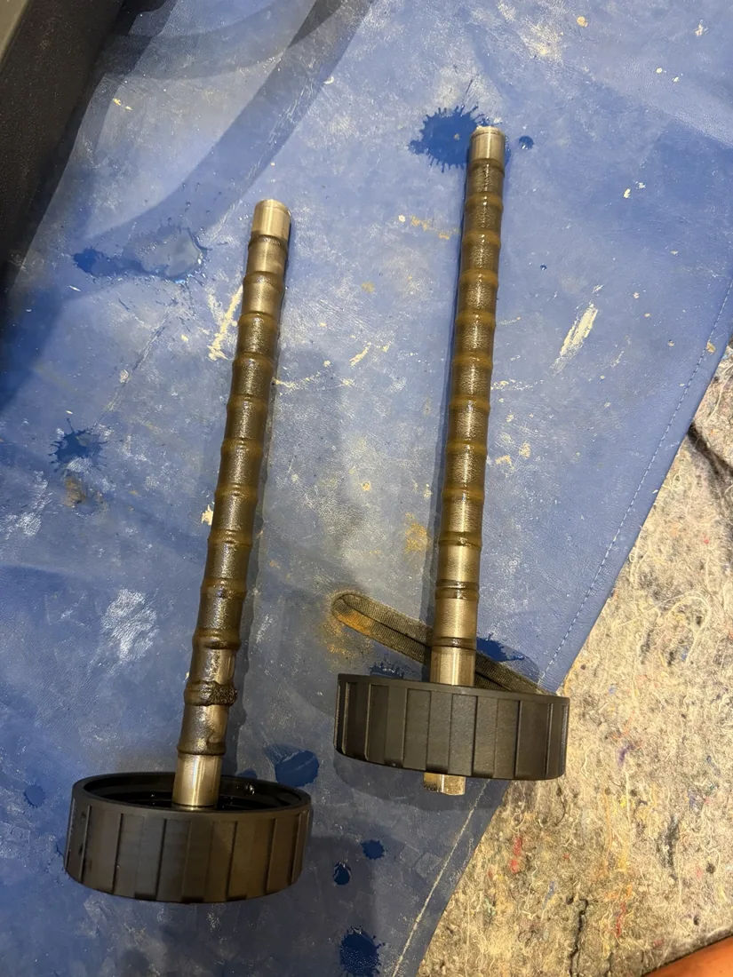 Dark magnetic deposits attached to MagnaCleanse collection rods
