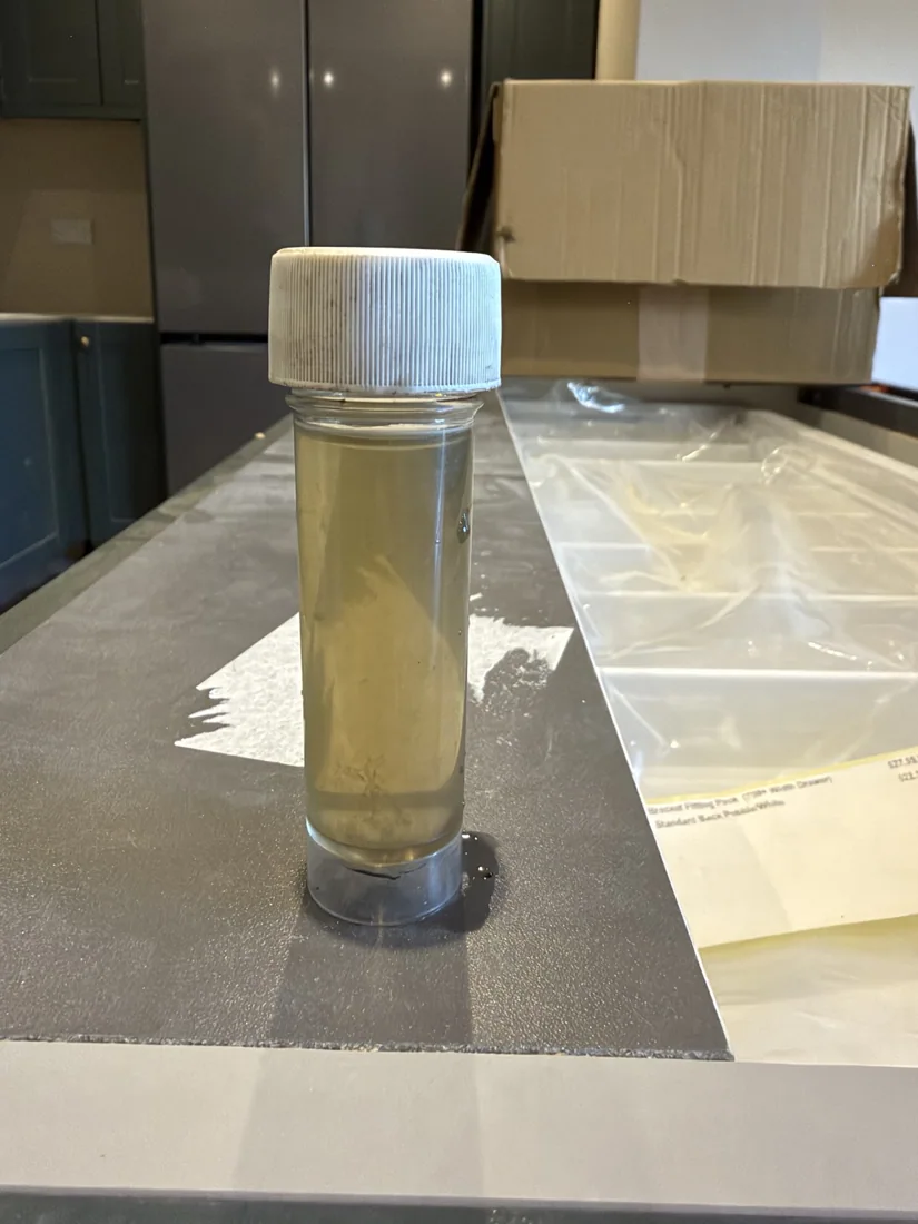 Pale, substantially clearer final heating water sample after cold flushing